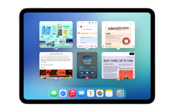 iPad, nằm ngang, màn hình hiển thị sáu cửa sổ mở thành hai hàng, bao gồm ứng dụng Lịch, ứng dụng Ghi Chú, Apple Music và Safari